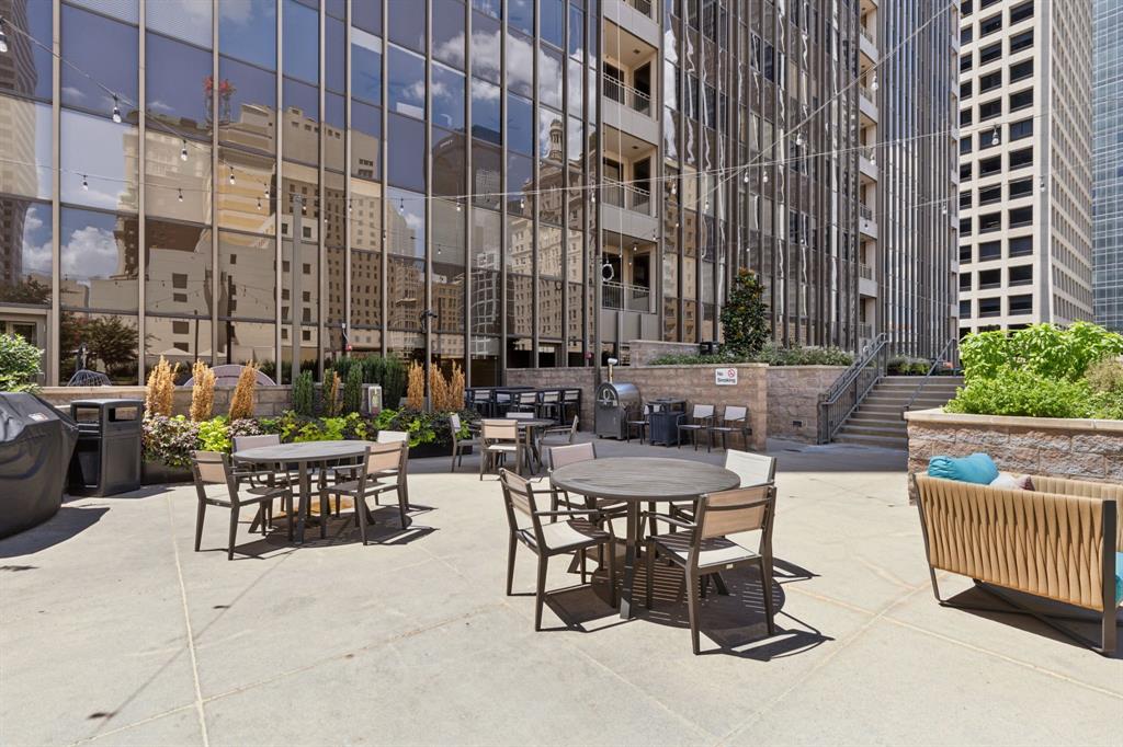 1200 Main Street, Unit 2302 Dallas, TX 75202 - Photo 17 of 22 a view of a patio with couches table and chairs