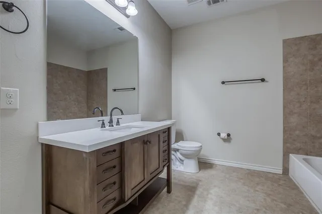 a bathroom with a toilet sink and a mirror