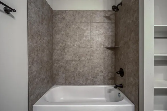 a bath tub sitting next to a white sink