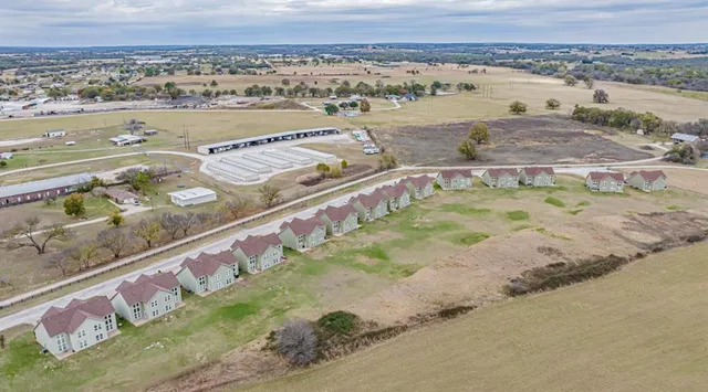 an aerial view of residential houses with outdoor space