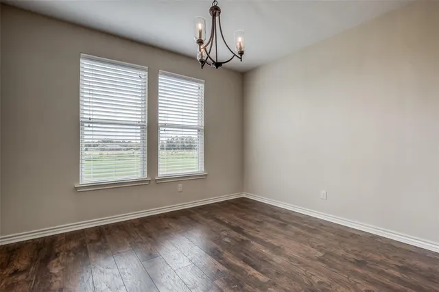 a view of a livingroom with wooden floor and a window