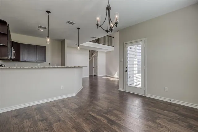 a view of a kitchen with a sink wooden floor and a window