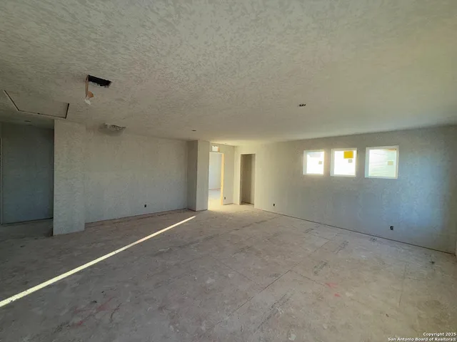 a view of an empty room and a window