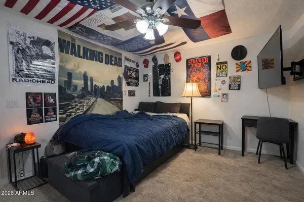 a bedroom with a bed and a chandelier
