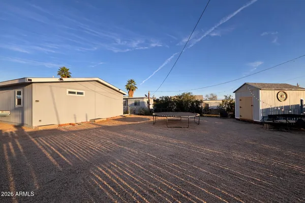 a view of a car park in front of a house