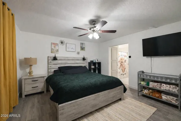 a bedroom with a bed and a flat screen tv
