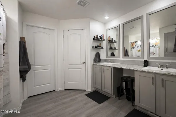 a kitchen with kitchen island white cabinets and stainless steel appliances