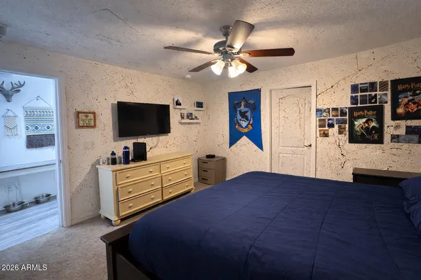 a bedroom with furniture and flat screen tv