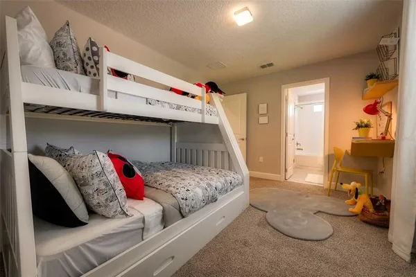 a bedroom with a bed and a couch