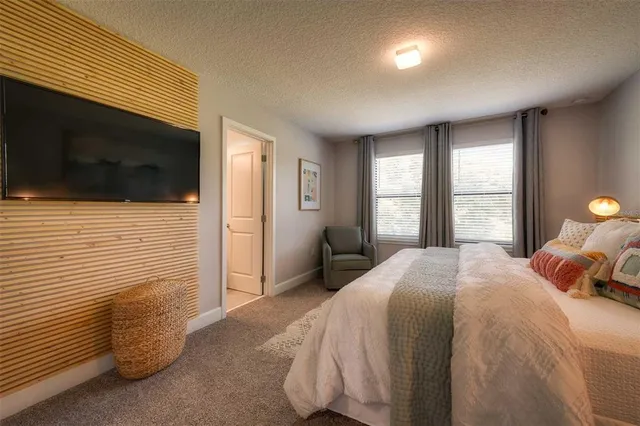 a bedroom with a bed and a television