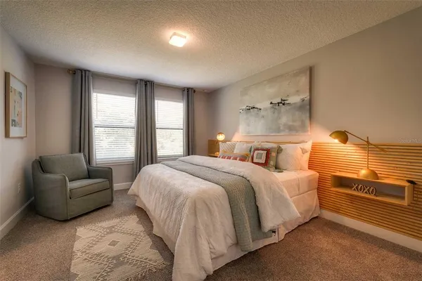a bedroom with a bed and a couch