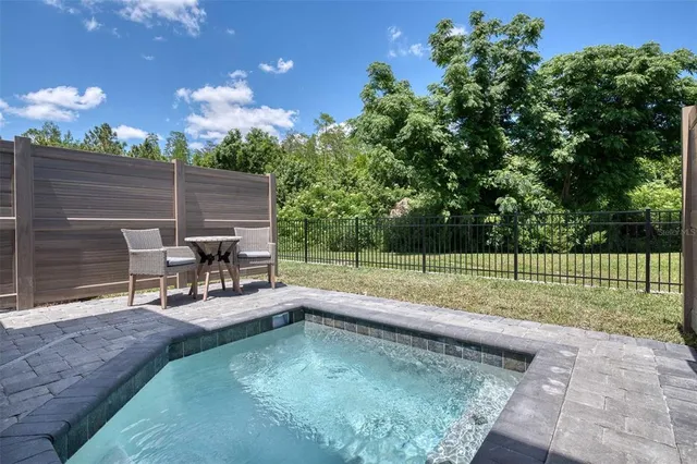 a view of a backyard with sitting area and couch