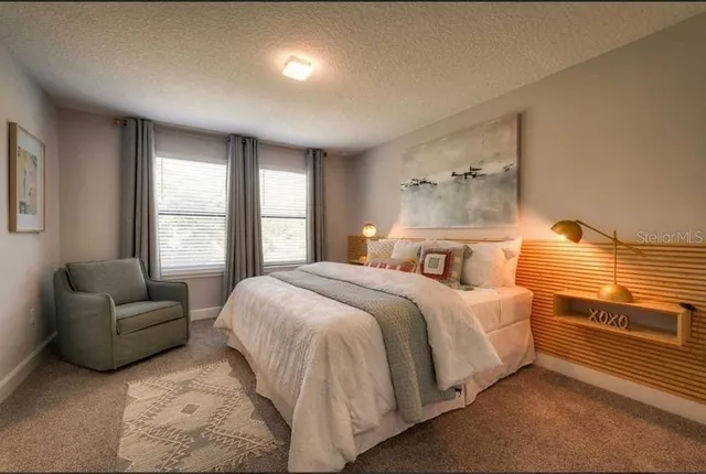 a bedroom with a bed and a couch