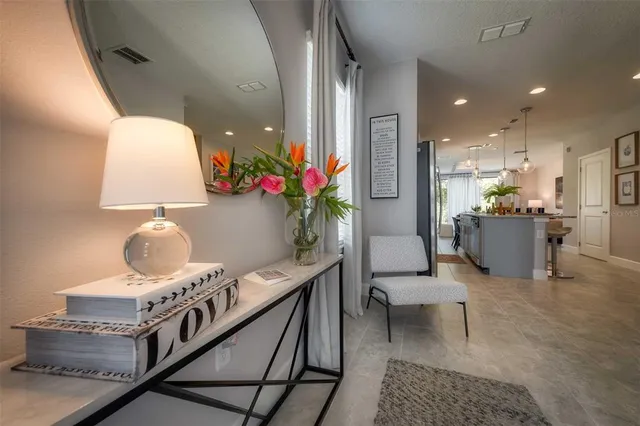 a living room with furniture and a potted plant