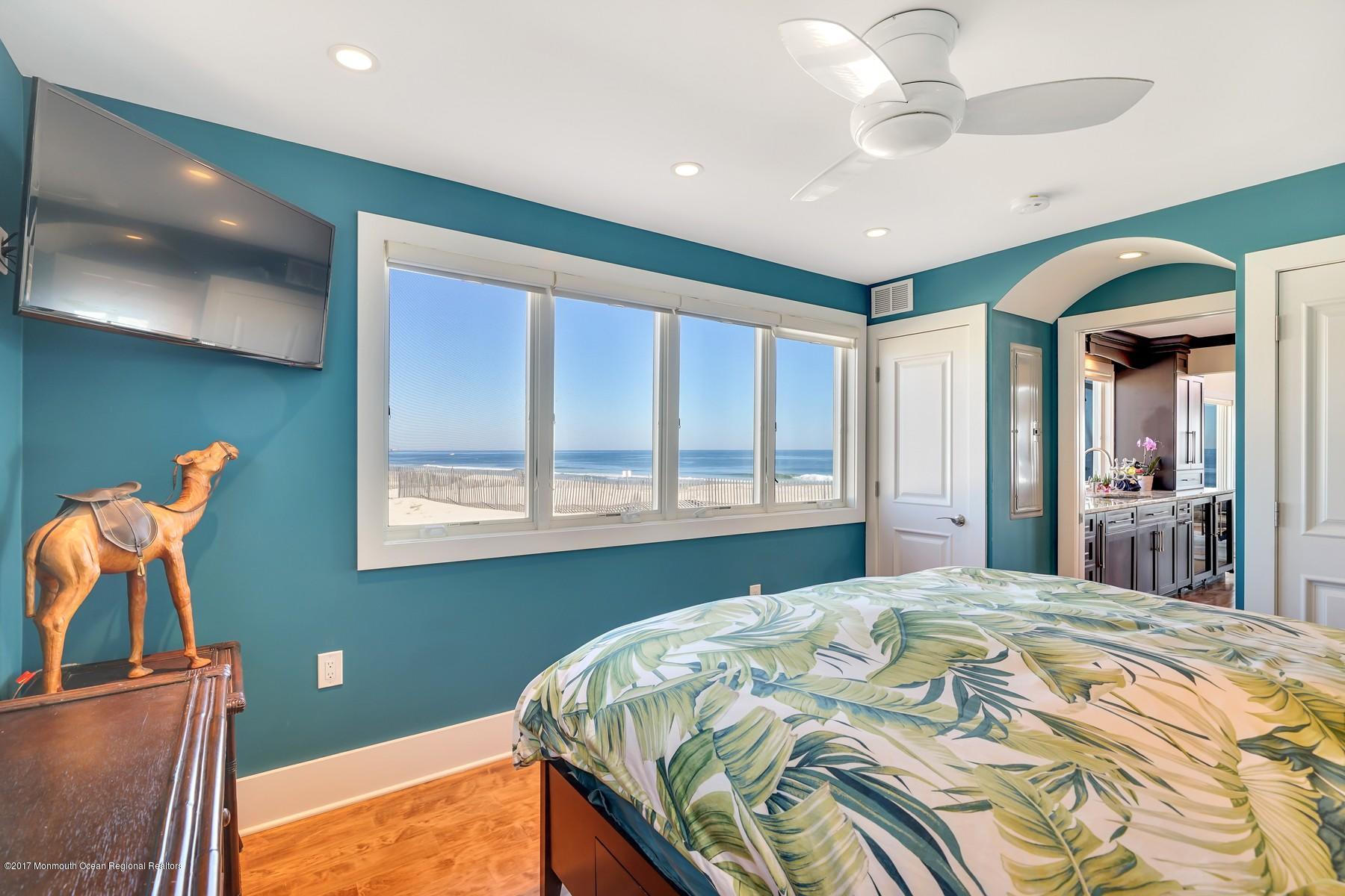 10 East Colony Road Lavallette, NJ 08735 - Photo 17 of 42 a bedroom with a bed and a chandelier