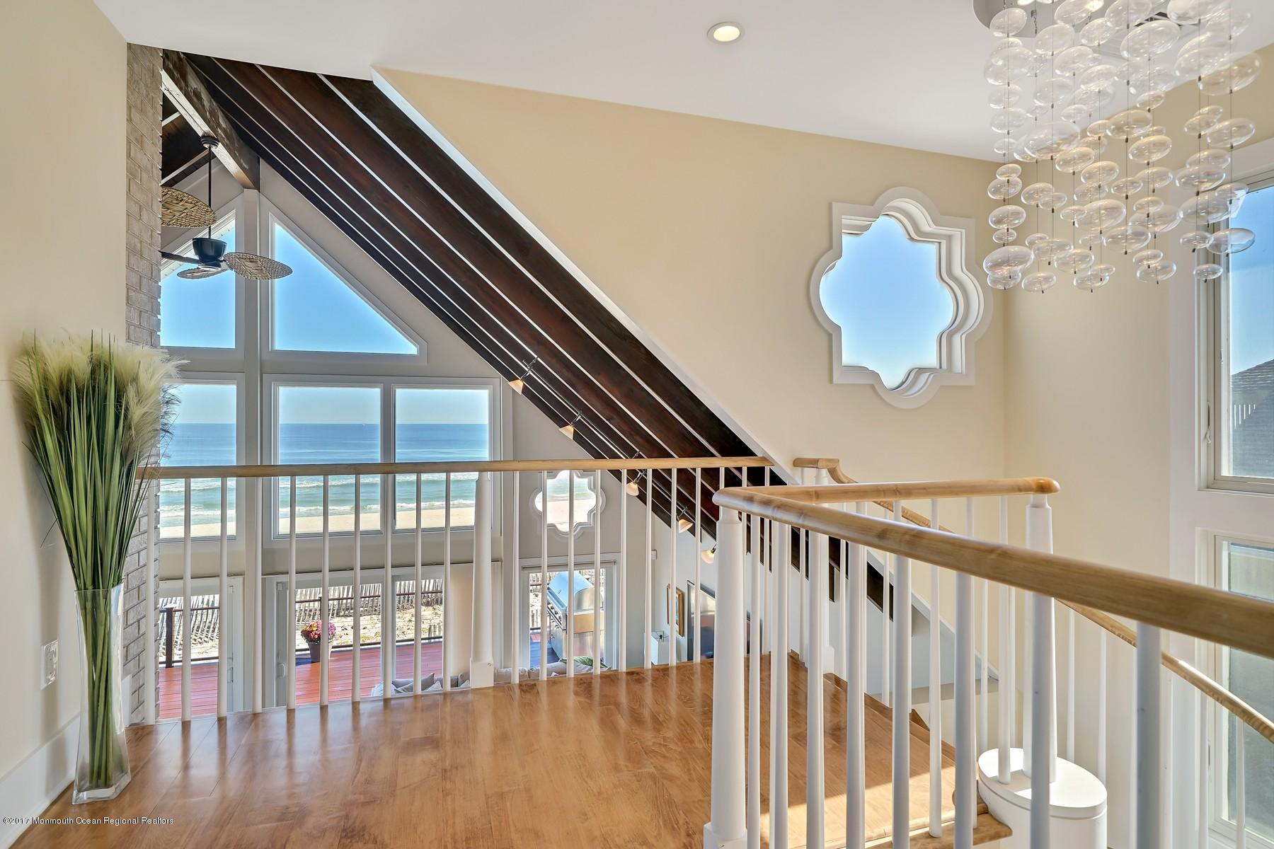 10 East Colony Road Lavallette, NJ 08735 - Photo 22 of 42 a view of staircase with lots of frames on wall and wooden floor