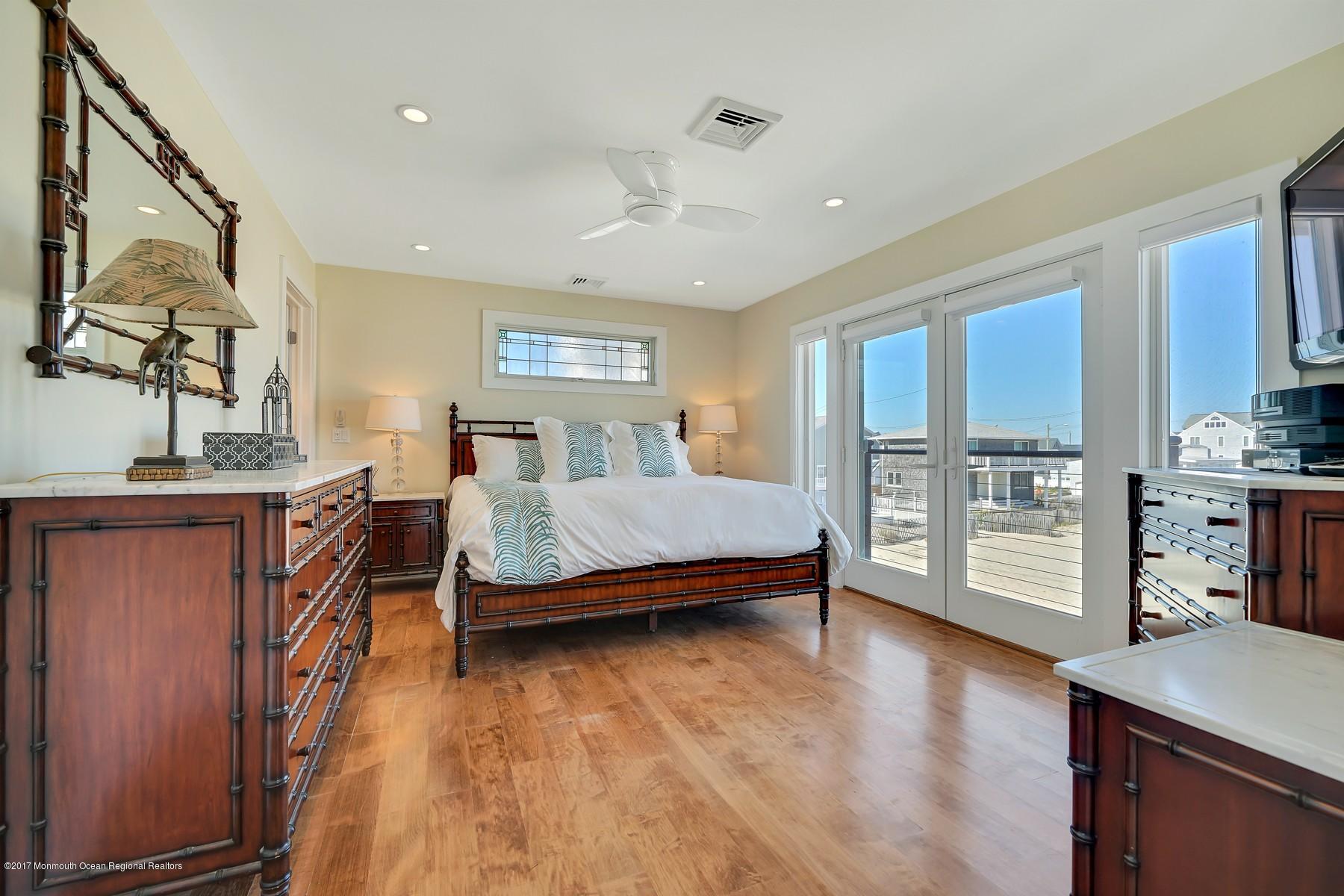 10 East Colony Road Lavallette, NJ 08735 - Photo 27 of 42 a spacious bedroom with a bed and a dresser in it