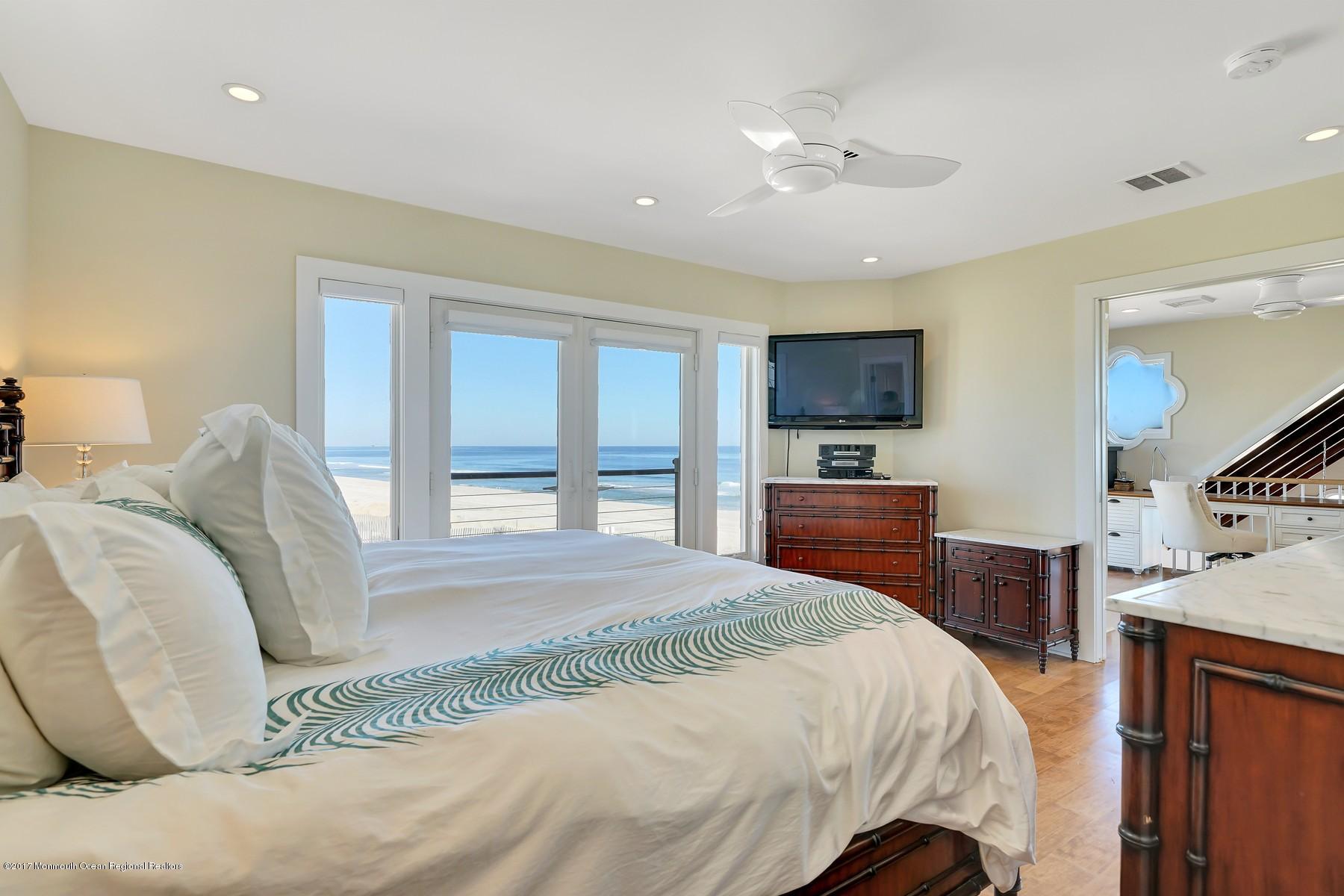 10 East Colony Road Lavallette, NJ 08735 - Photo 28 of 42 a bedroom with a large bed and a flat tv screen on dresser