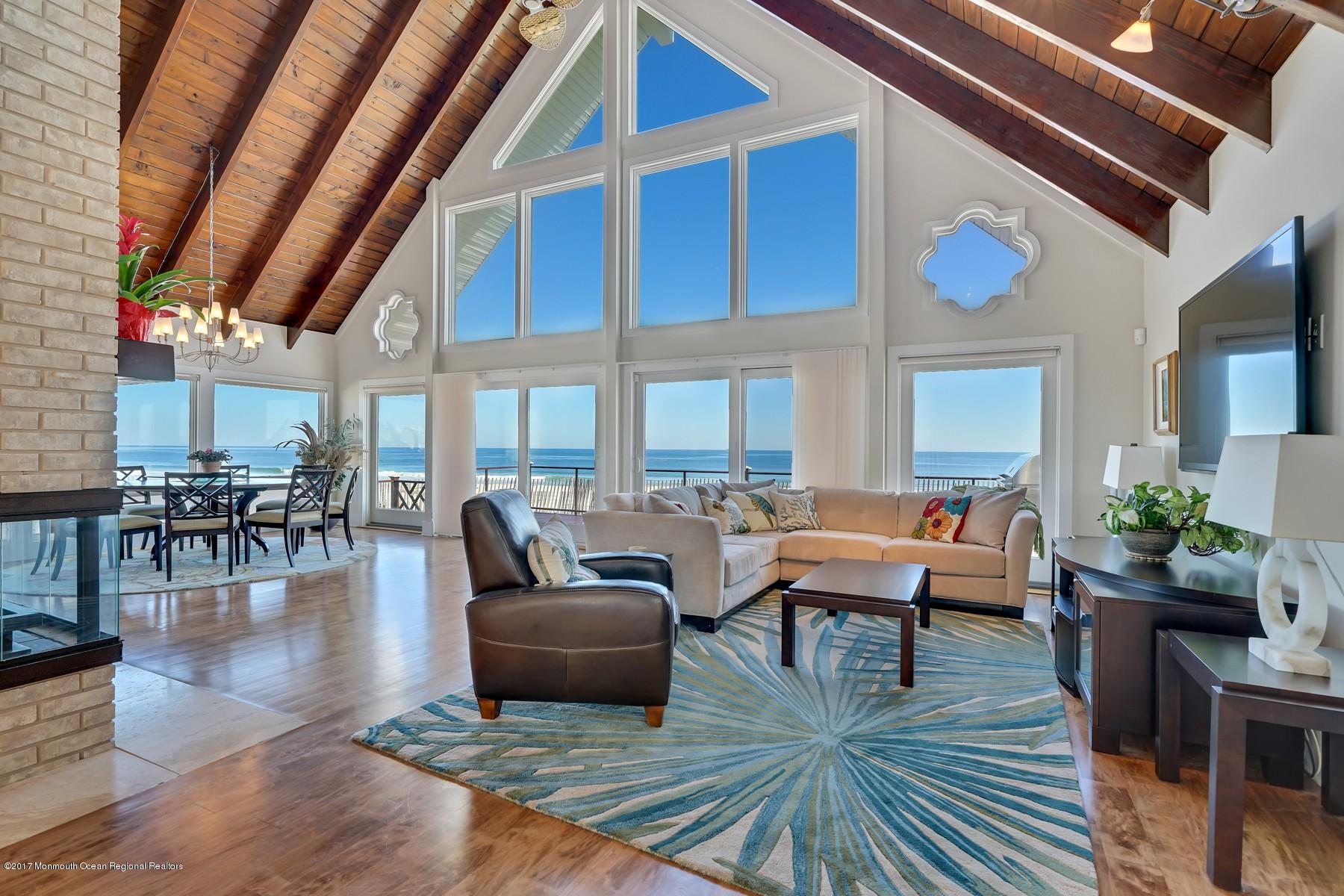 10 East Colony Road Lavallette, NJ 08735 - Photo 7 of 42 a living room with furniture a rug and a floor to ceiling window