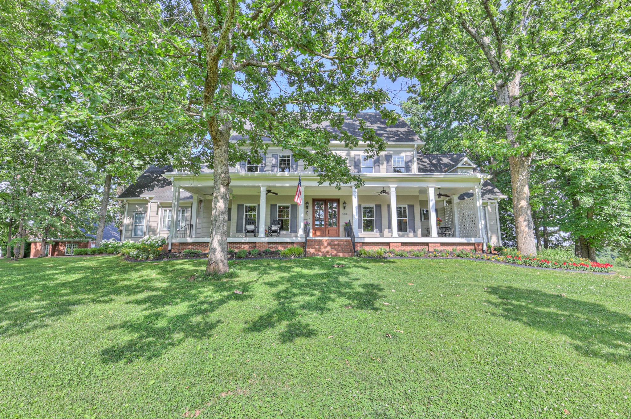 a front view of a house with a garden