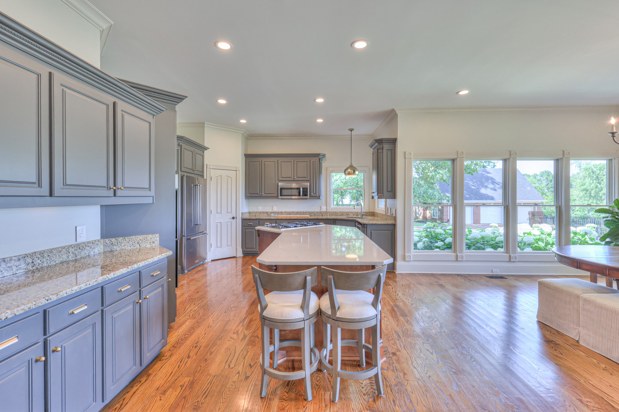 4288 Central Valley Road Murfreesboro, TN 37129 - Photo 26 of 77 a kitchen with stainless steel appliances granite countertop a kitchen island hardwood floor sink stove dining table and chairs