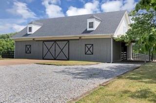 4288 Central Valley Road Murfreesboro, TN 37129 - Photo 74 of 77 a front view of a house with a yard and a garage
