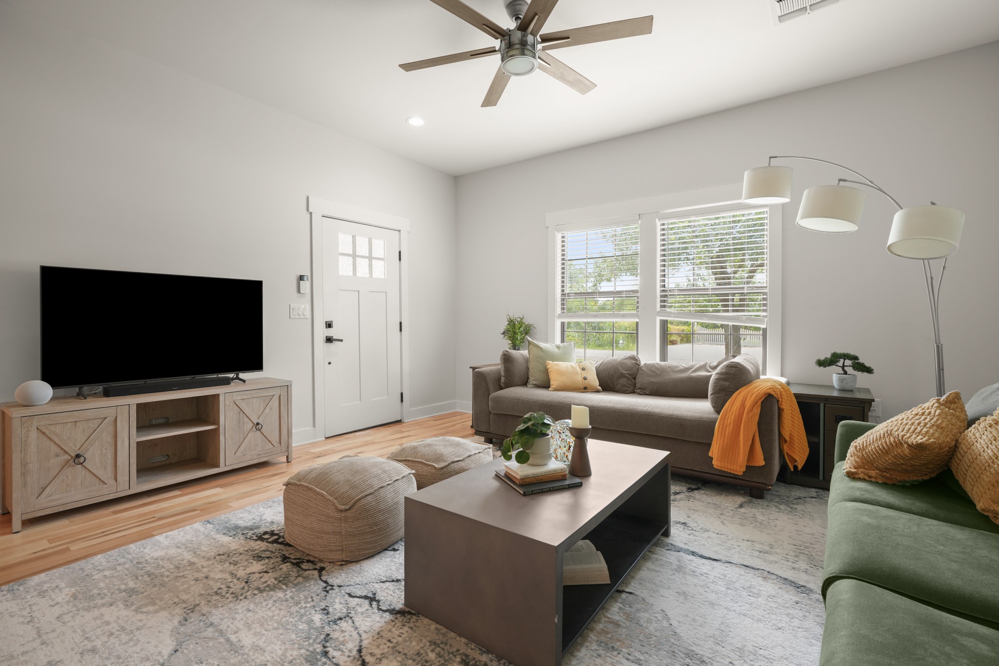 301 Old Thorndale Road Taylor, TX 76574 - Photo 7 of 29 Comfortable living area showcasing durable hardwood flooring and a ceiling fan for year-round comfort.