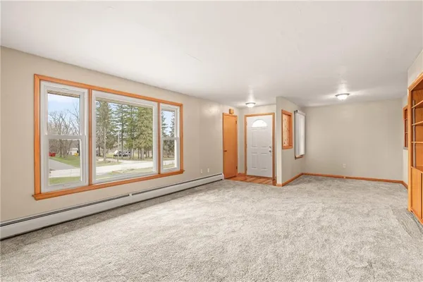 an empty room with windows and closet