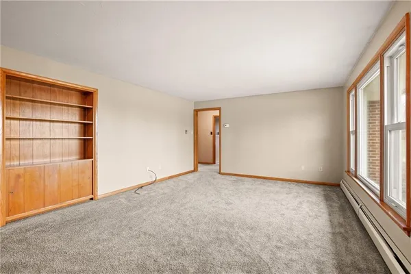 a kitchen with granite countertop cabinets stainless steel appliances a sink and a large window