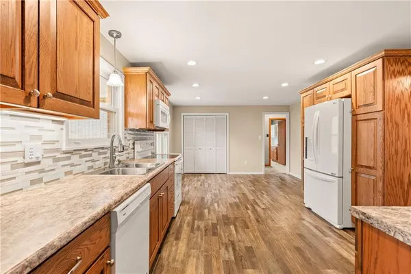 a kitchen with stainless steel appliances a refrigerator and a stove top oven