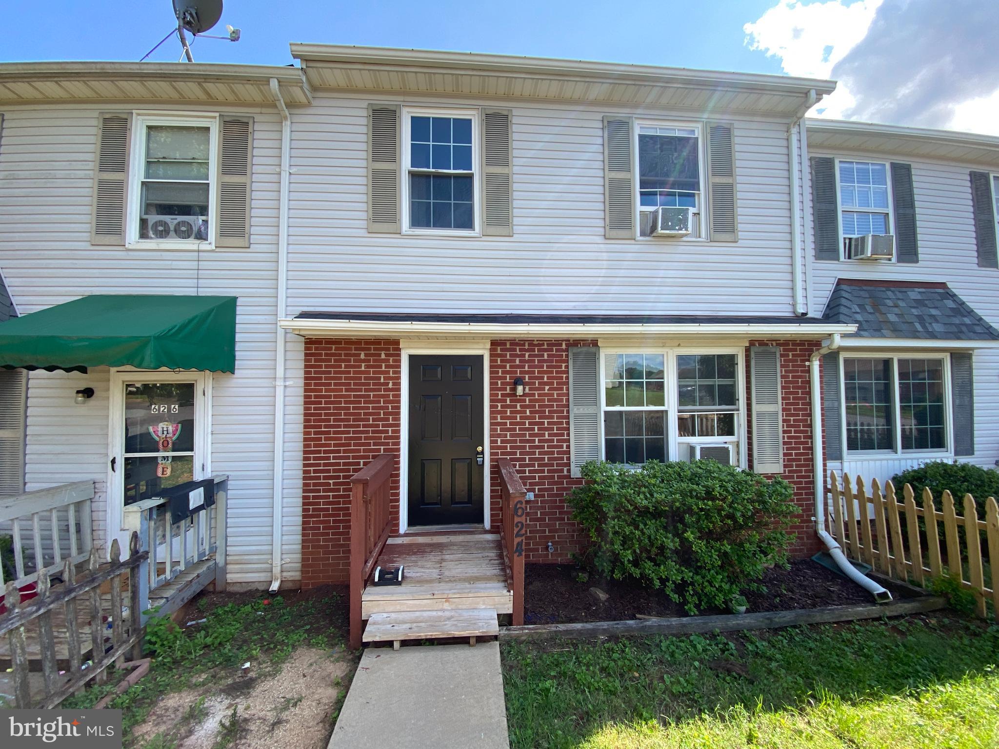 624 Highview Court Culpeper, VA 22701 - Photo 2 of 21 a view of a brick house with brick walls plants and large tree