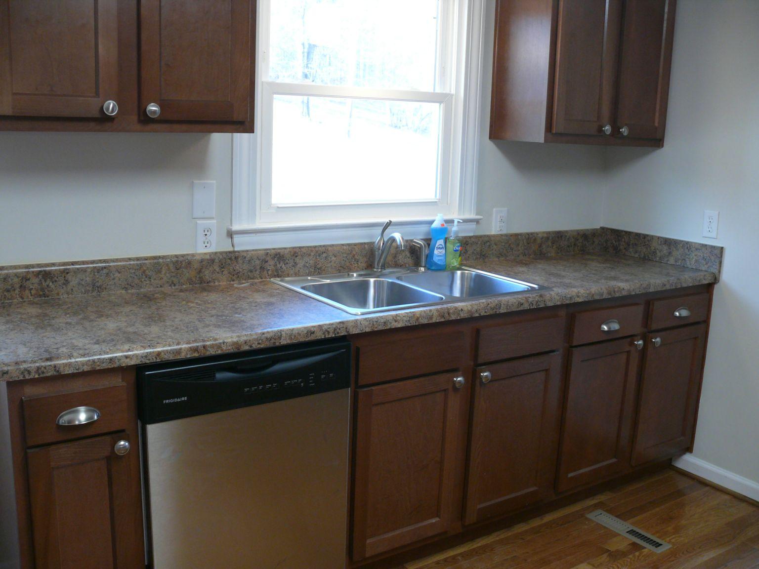 409 Republican Church Road Ferrum, VA 24088 - Photo 9 of 28 a kitchen with granite countertop cabinets sink and window