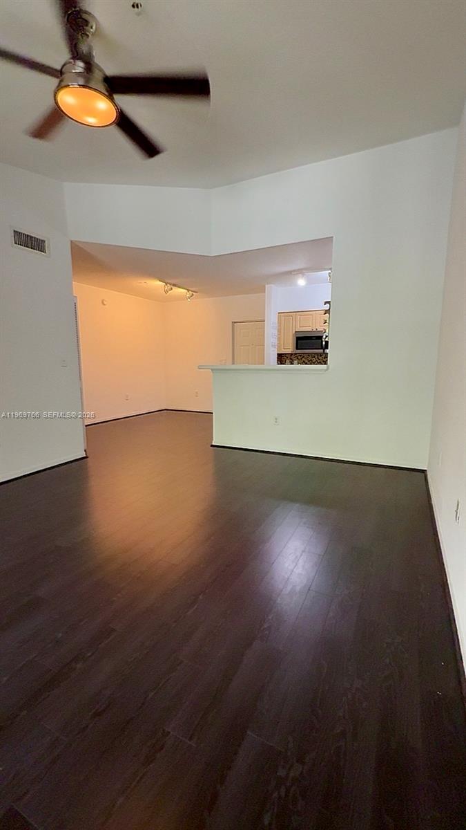6831 Southwest 44th Street, Unit 302 Miami, FL 33155 - Photo 4 of 28 a view of a room with wooden floor and window