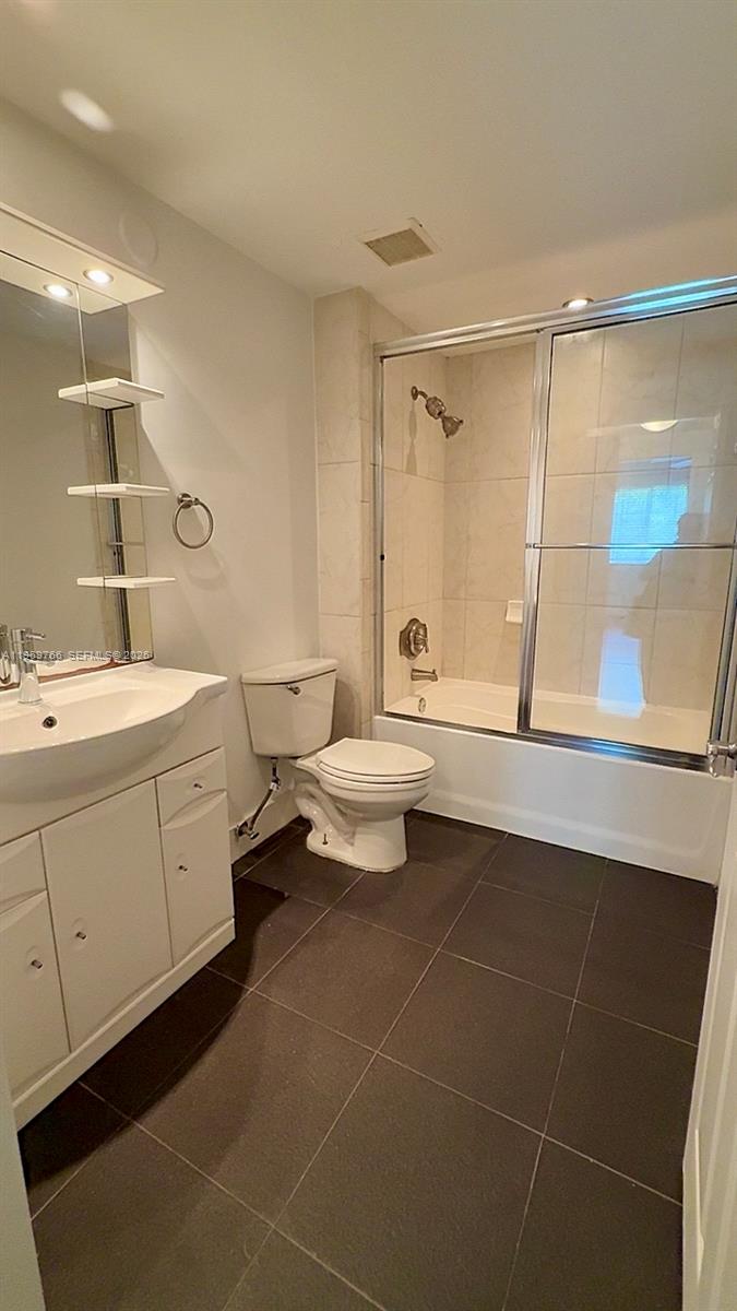 6831 Southwest 44th Street, Unit 302 Miami, FL 33155 - Photo 7 of 28 a bathroom with a double vanity sink mirror and toilet