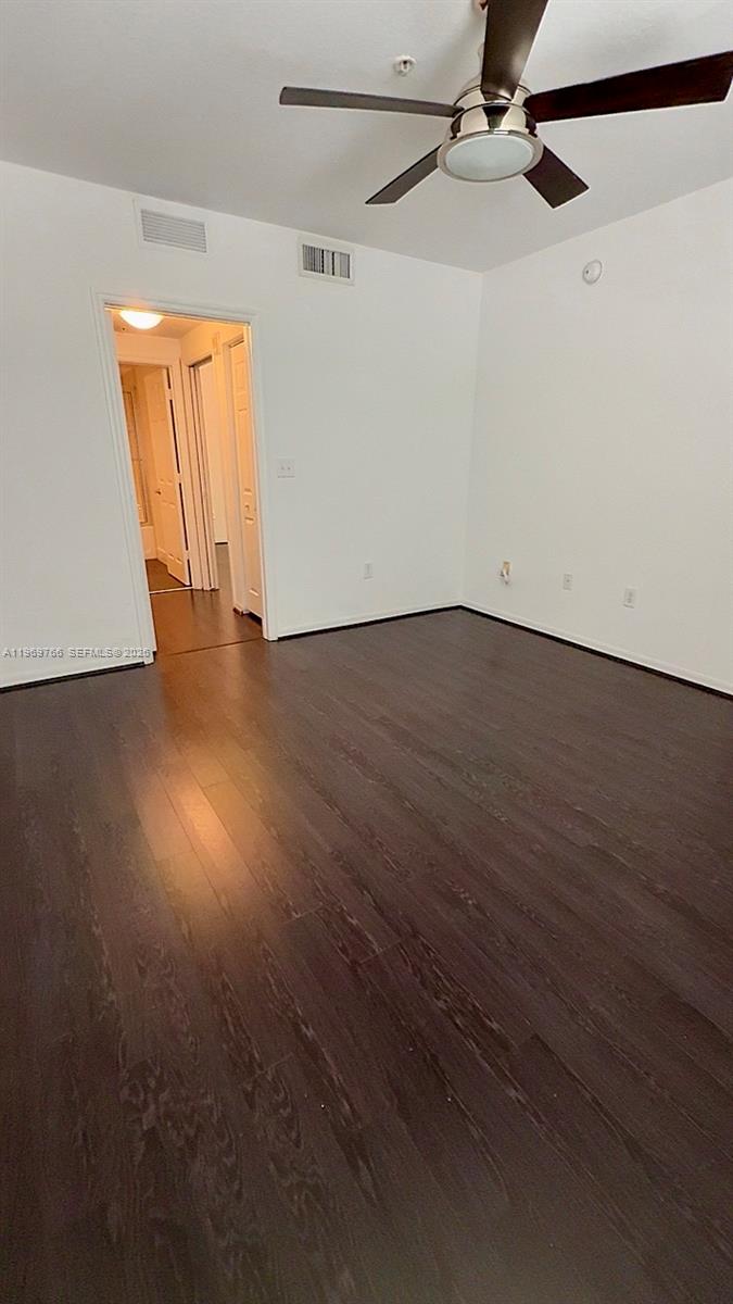 6831 Southwest 44th Street, Unit 302 Miami, FL 33155 - Photo 8 of 28 an empty room with wooden floor and windows