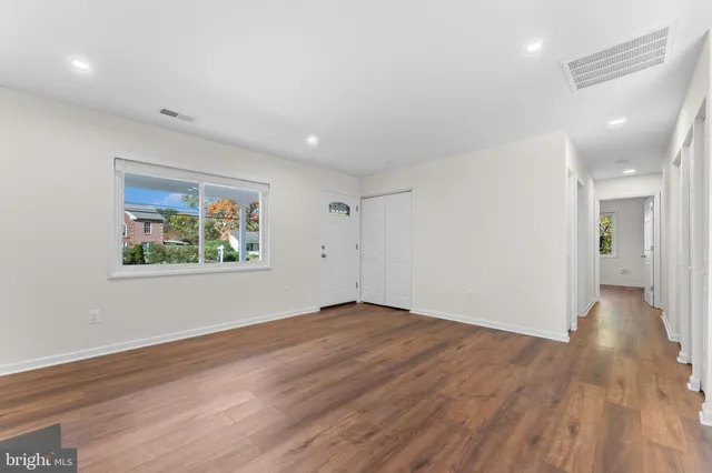 a kitchen with a stove and a wooden floor