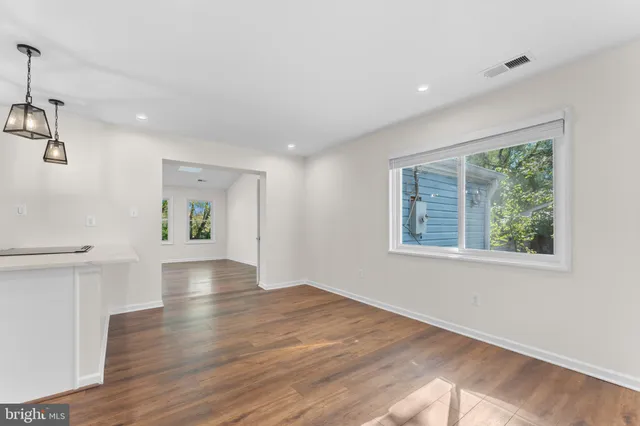 a kitchen with a stove and a chandelier