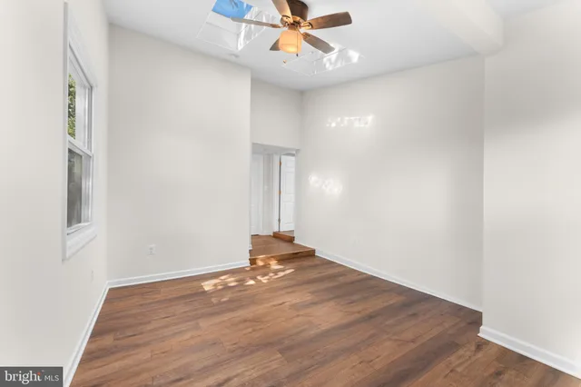 wooden floor in an empty room with a window