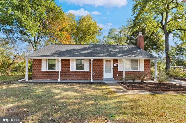 front view of a brick house with a large window