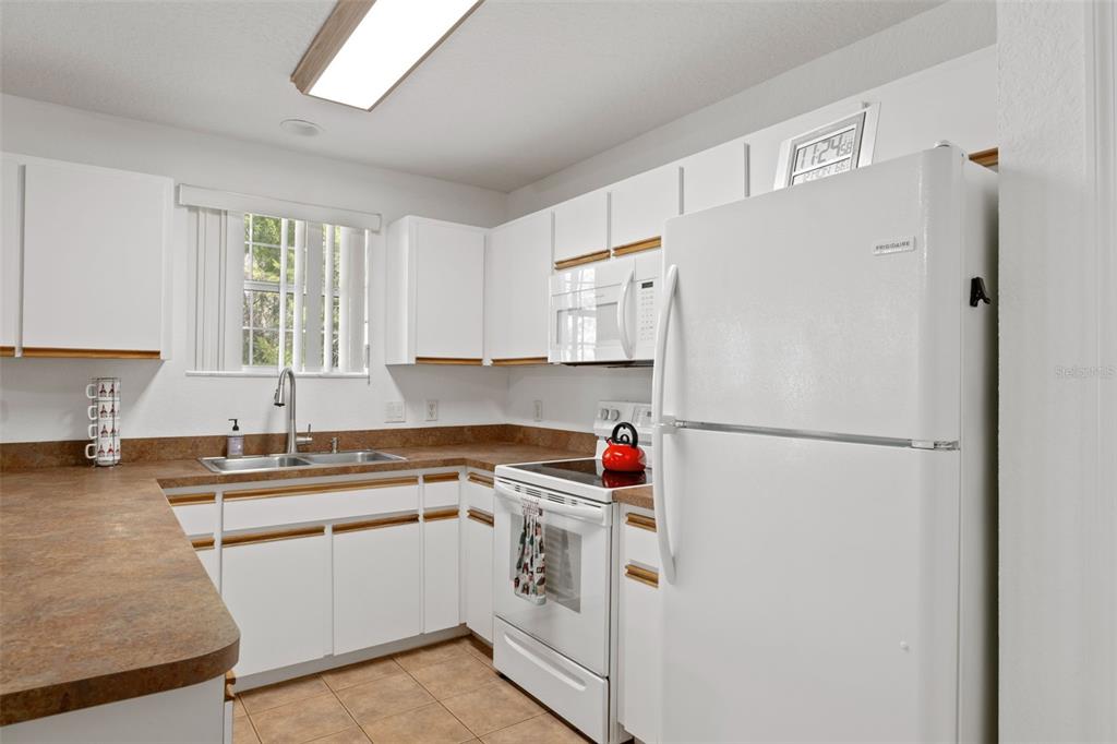 3493 East Odier Street Inverness, FL 34453 - Photo 11 of 24 a utility room with cabinets washer and dryer