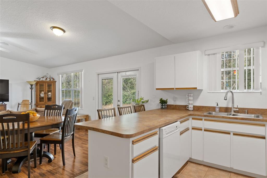 3493 East Odier Street Inverness, FL 34453 - Photo 12 of 24 a kitchen that has a sink a table and chairs in it