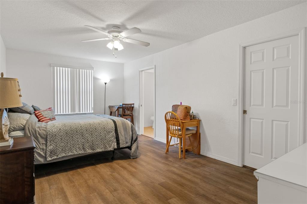 3493 East Odier Street Inverness, FL 34453 - Photo 13 of 24 a bedroom with a bed and a chandelier