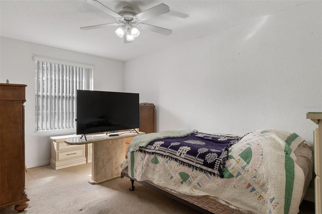 3493 East Odier Street Inverness, FL 34453 - Photo 18 of 24 a bedroom with a bed and a flat screen tv