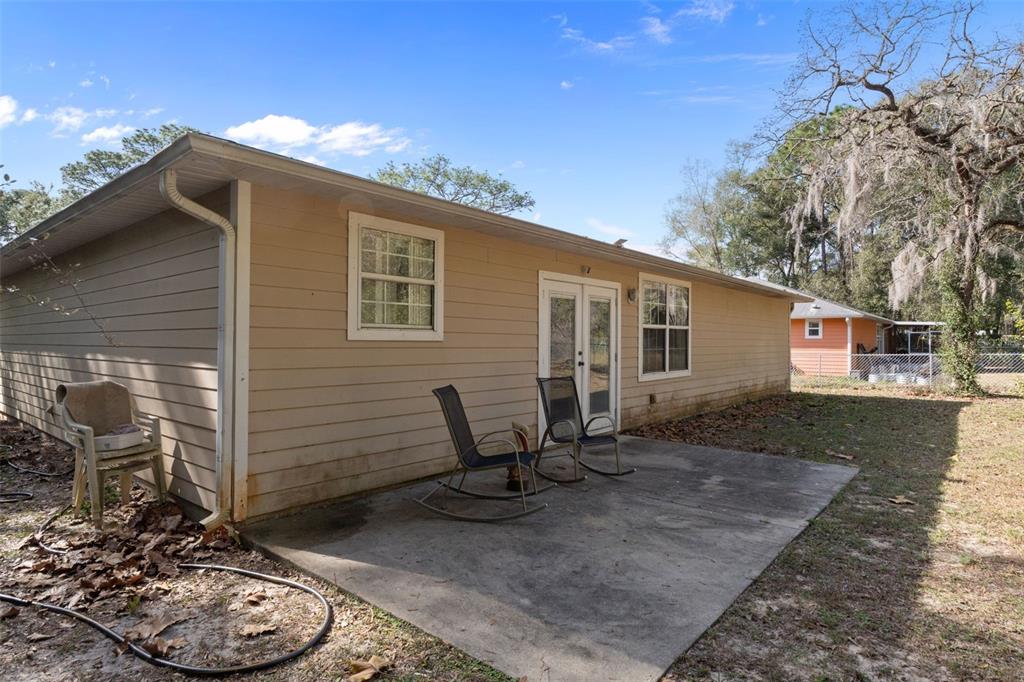 3493 East Odier Street Inverness, FL 34453 - Photo 22 of 24 a backyard of a house with table and chairs