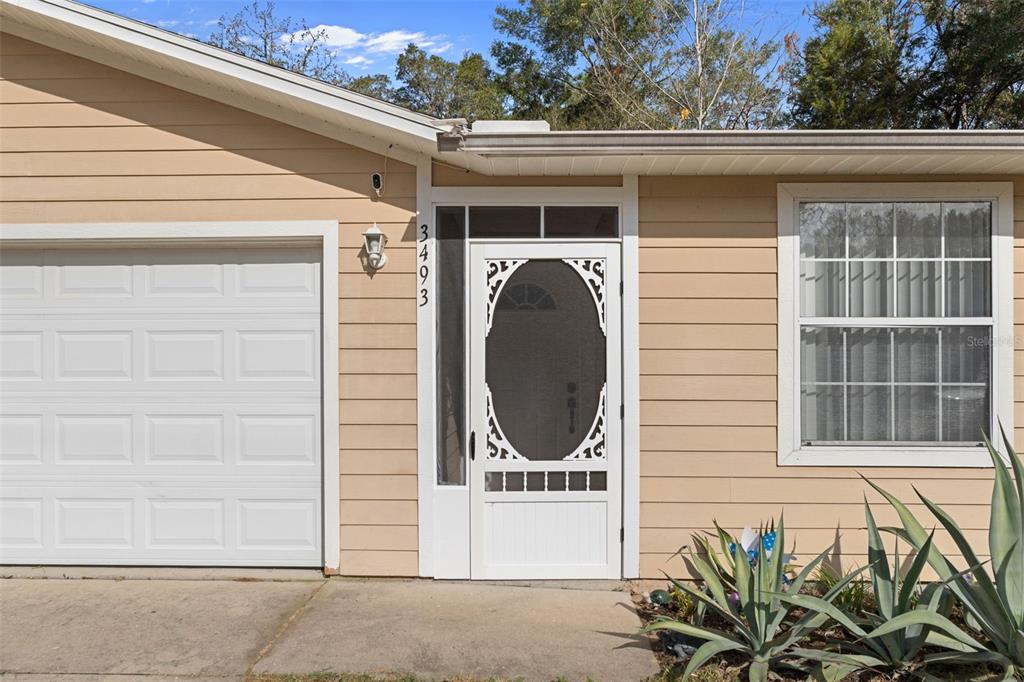 3493 East Odier Street Inverness, FL 34453 - Photo 3 of 24 a front view of a house with a garage