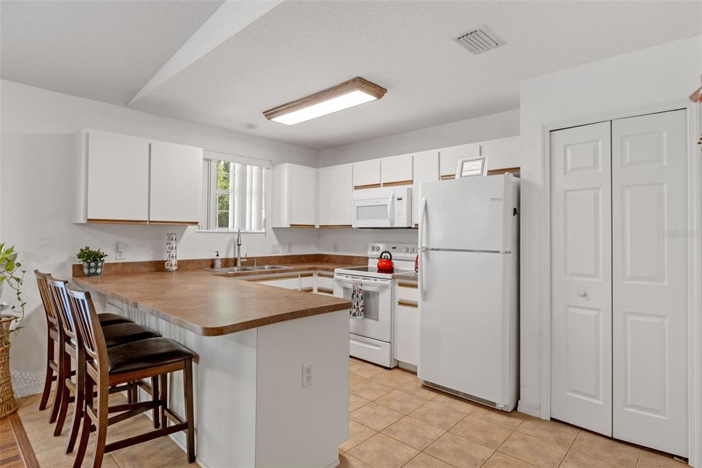 3493 East Odier Street Inverness, FL 34453 - Photo 10 of 24 a kitchen with refrigerator a stove a sink and a refrigerator