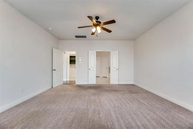 a view of empty room with ceiling fan