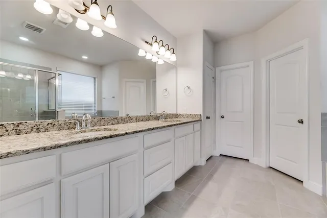 a bathroom with a sink double vanity and a mirror
