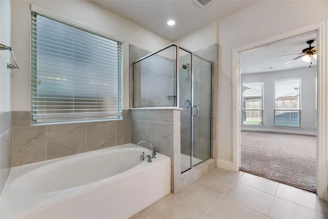 a bathroom with a bathtub and a shower