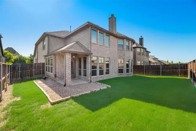 a view of a house with a yard and deck